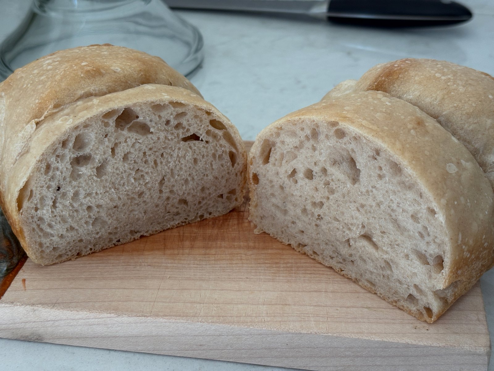 Sliced whole wheat sandwich loaf with golden crust and open custardy crumb